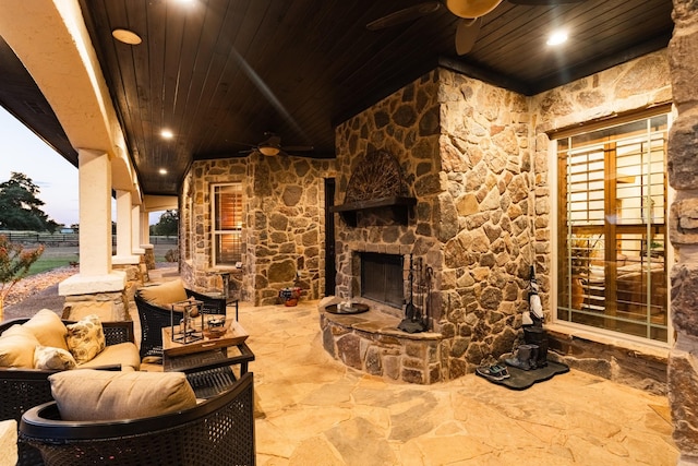 view of patio featuring ceiling fan and an outdoor stone fireplace