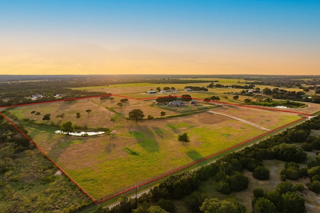 aerial view at dusk featuring a rural view