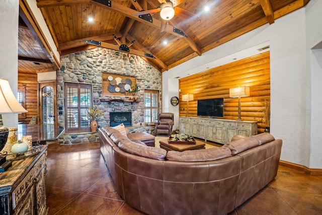 living room with a stone fireplace, ceiling fan, log walls, wooden ceiling, and beamed ceiling