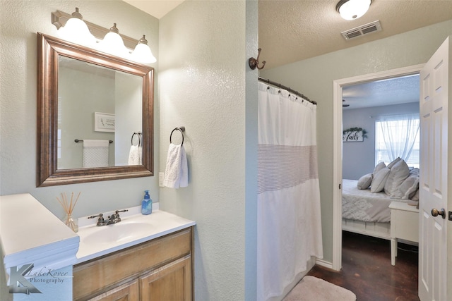 bathroom with vanity, a textured ceiling, and a shower with curtain