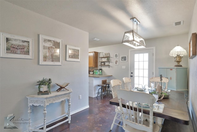 dining space with a textured ceiling