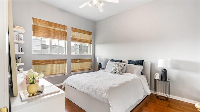 bedroom with dark hardwood / wood-style floors and ceiling fan