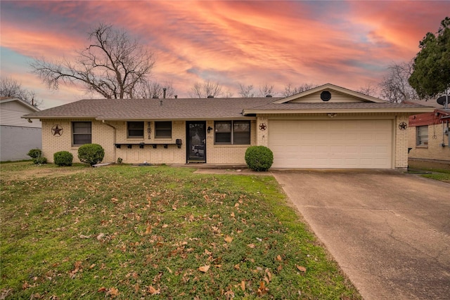 single story home with a garage and a lawn