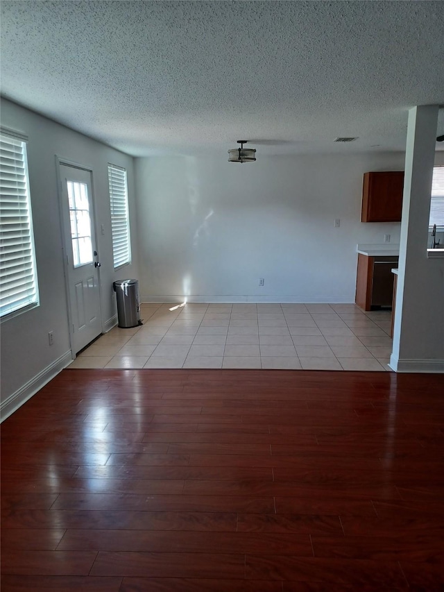 interior space featuring a textured ceiling and light hardwood / wood-style flooring