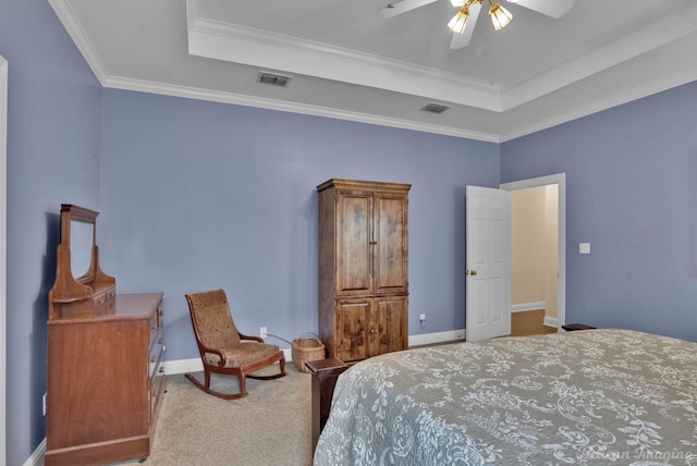 bedroom featuring light colored carpet, ornamental molding, a raised ceiling, and ceiling fan