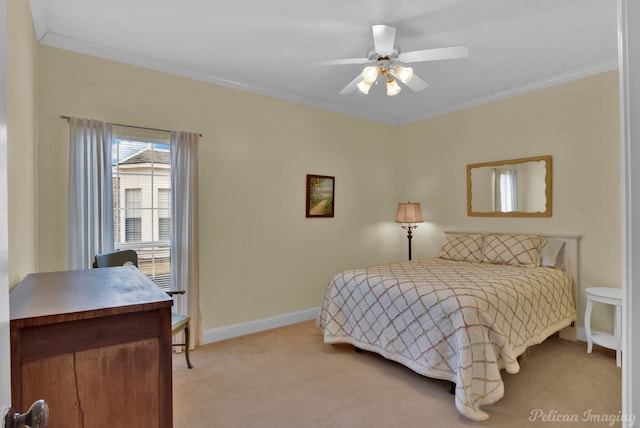 carpeted bedroom featuring ornamental molding and ceiling fan