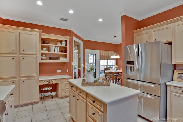 kitchen featuring stainless steel refrigerator with ice dispenser, crown molding, built in desk, a kitchen island, and pendant lighting