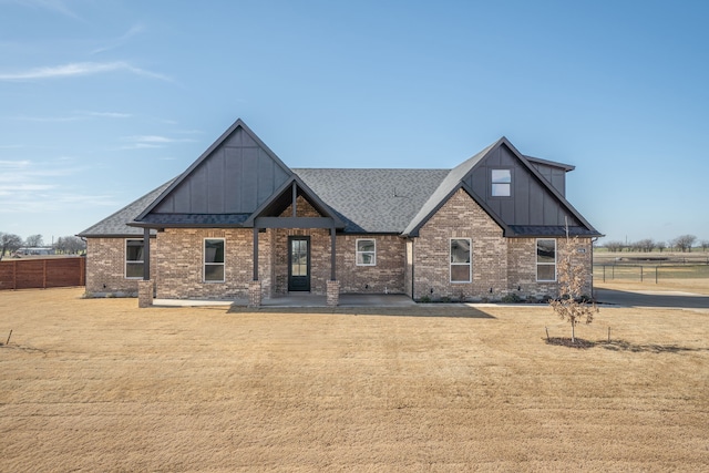 view of front of property featuring a patio area and a front lawn