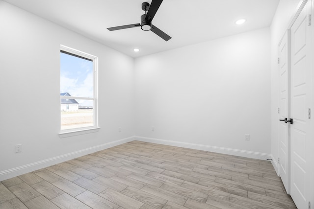 unfurnished room with ceiling fan and light wood-type flooring