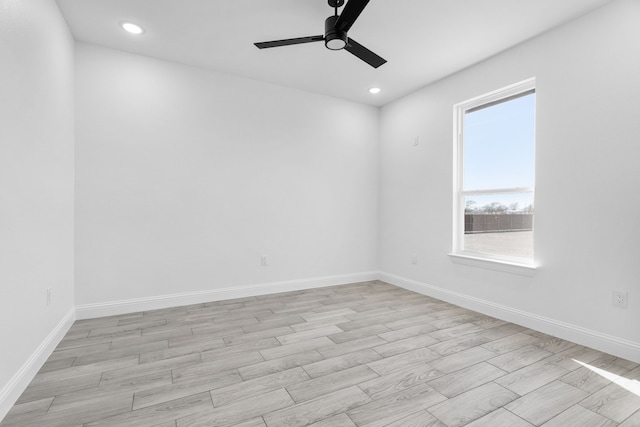 spare room with ceiling fan and light wood-type flooring