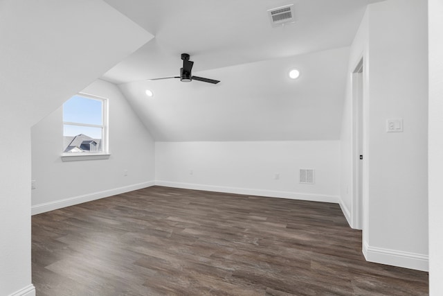 additional living space with lofted ceiling, dark wood-type flooring, and ceiling fan