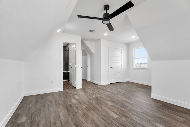 additional living space with wood-type flooring, lofted ceiling, and ceiling fan