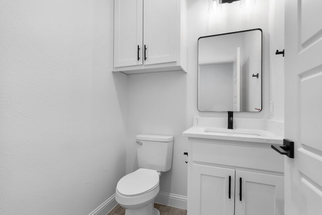 bathroom featuring hardwood / wood-style flooring, vanity, and toilet