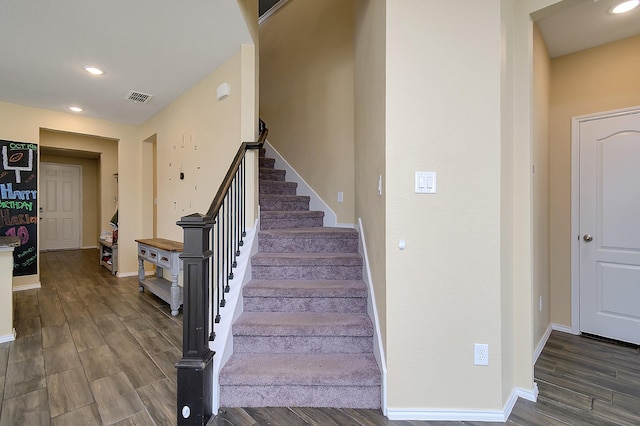 stairs featuring hardwood / wood-style flooring