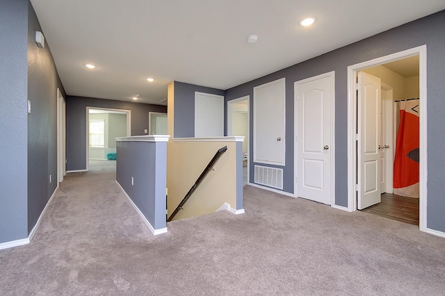 corridor with light carpet