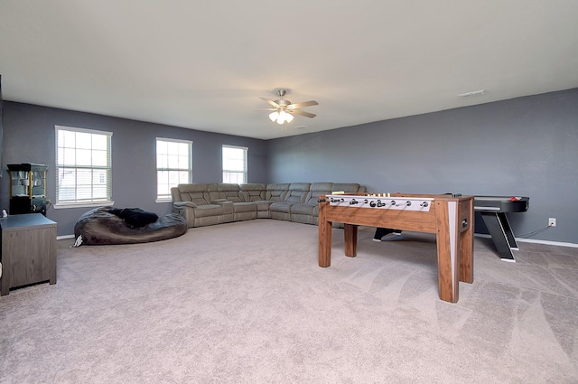 game room with ceiling fan and light carpet