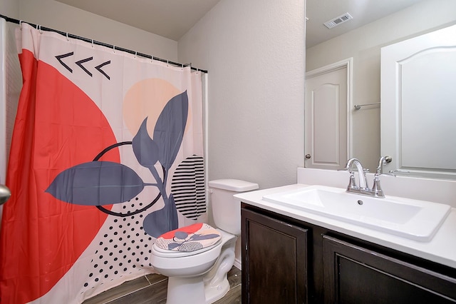 bathroom with vanity, wood-type flooring, a shower with shower curtain, and toilet