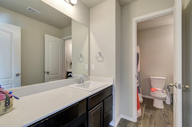 bathroom featuring vanity and toilet