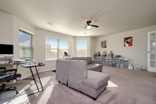 carpeted living room with ceiling fan