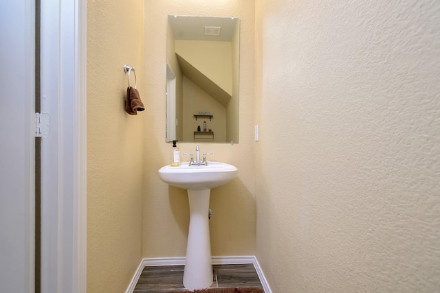 bathroom with hardwood / wood-style flooring