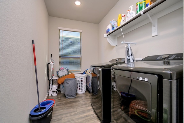 clothes washing area with washing machine and clothes dryer