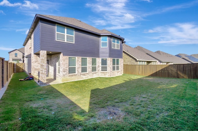 back of house with a lawn