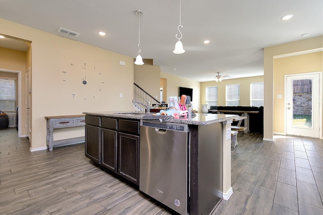 kitchen featuring sink, hanging light fixtures, dark brown cabinets, an island with sink, and stainless steel dishwasher