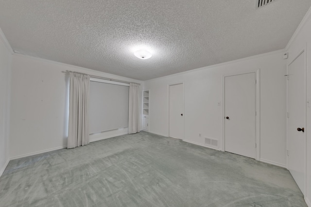 carpeted empty room with crown molding, a baseboard radiator, and a textured ceiling