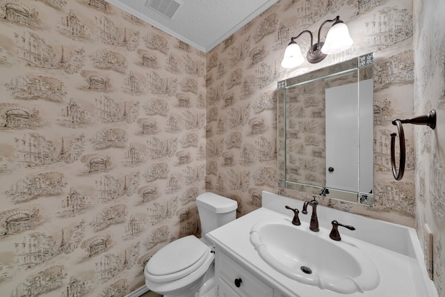 bathroom with vanity, toilet, and a textured ceiling