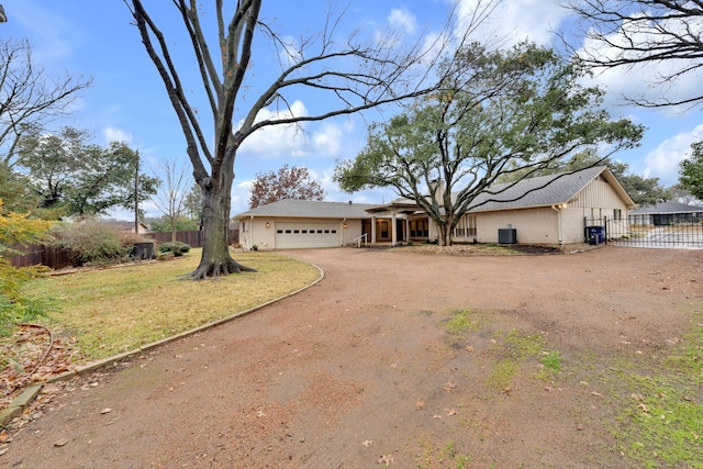 ranch-style house featuring a garage and a front yard