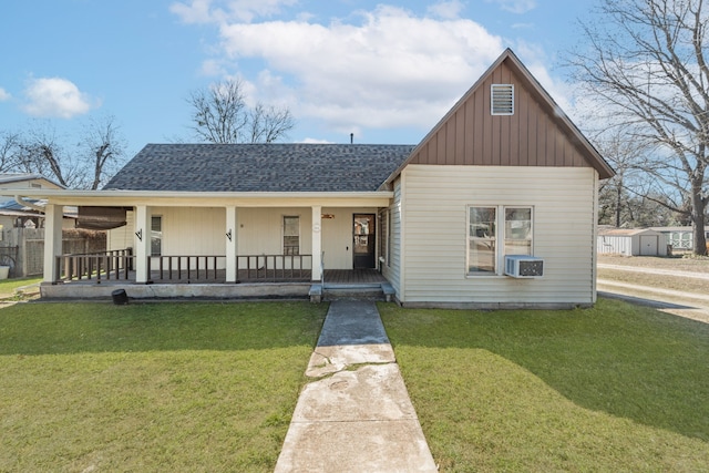 view of front of property with a porch, a front yard, and a storage unit