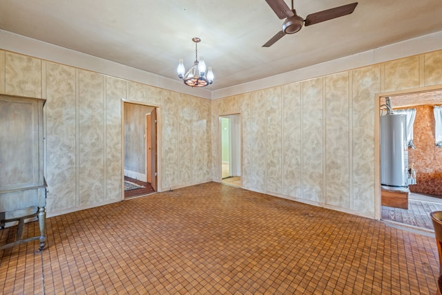 spare room with ceiling fan with notable chandelier and water heater