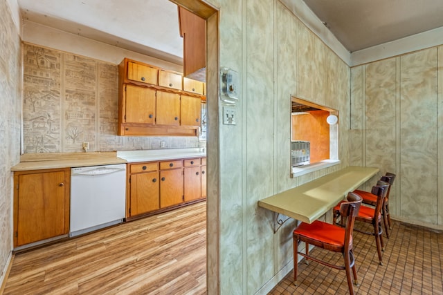 kitchen with white dishwasher and light wood-type flooring