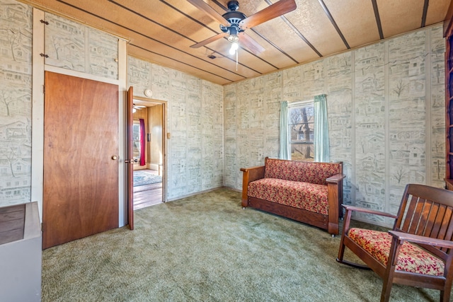 sitting room with ceiling fan and carpet flooring