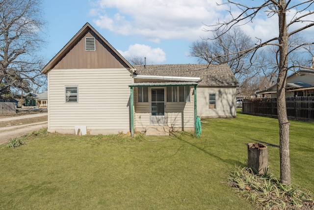 rear view of house featuring a lawn