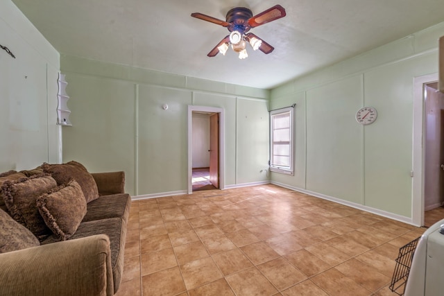 tiled living room with ceiling fan