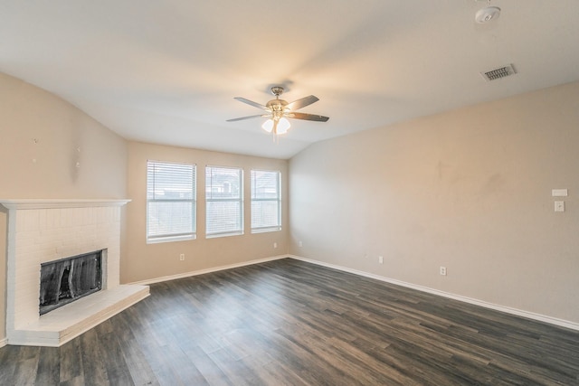 unfurnished living room with ceiling fan, dark wood-type flooring, and a fireplace