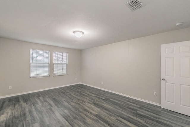 unfurnished room featuring a textured ceiling and dark hardwood / wood-style flooring