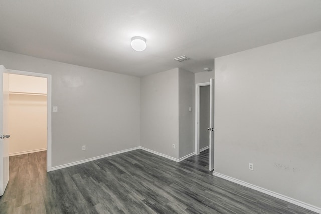 unfurnished room featuring dark wood-type flooring