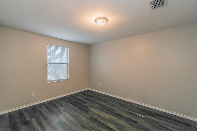 empty room featuring dark hardwood / wood-style flooring