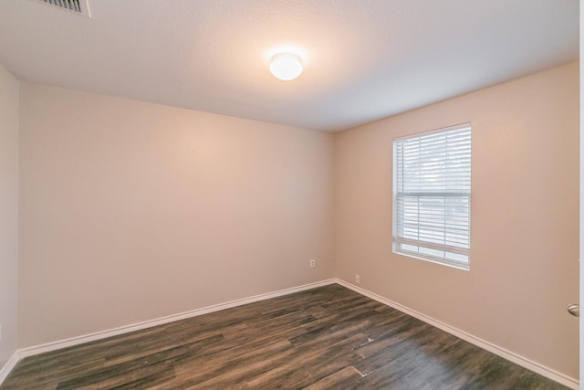 spare room featuring dark hardwood / wood-style floors