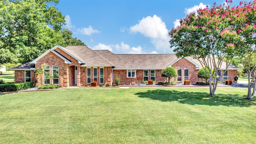 ranch-style home featuring a front yard