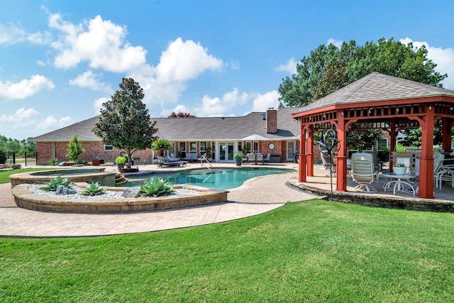 view of pool featuring a gazebo, a lawn, an in ground hot tub, and a patio area