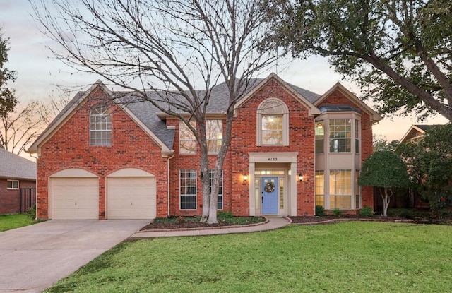 front facade featuring a yard and a garage