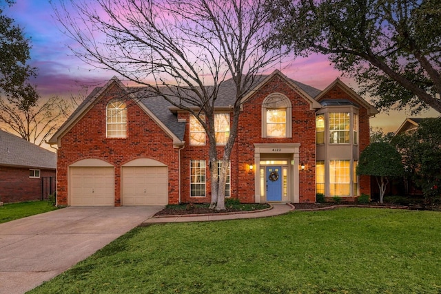 view of front property featuring a garage and a lawn