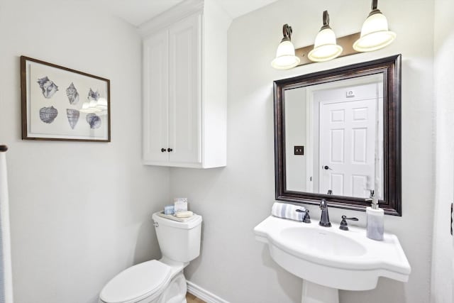 bathroom featuring sink and toilet