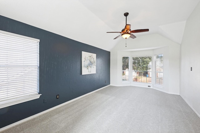 unfurnished room with ceiling fan, vaulted ceiling, and carpet