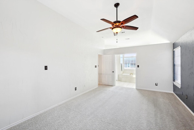 spare room with ceiling fan and light carpet