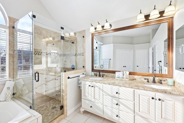 bathroom with independent shower and bath, vanity, lofted ceiling, and tile patterned flooring