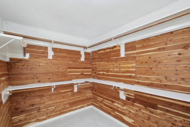 spacious closet with light tile patterned floors